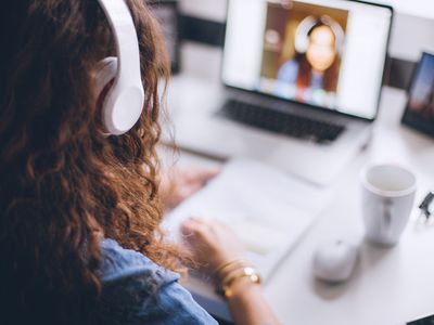 A woman is video chatting via her laptop's webcam.