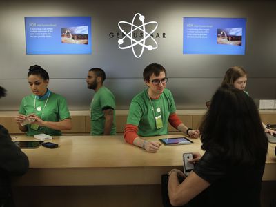 Employees and customers at the Apple Genius Bar