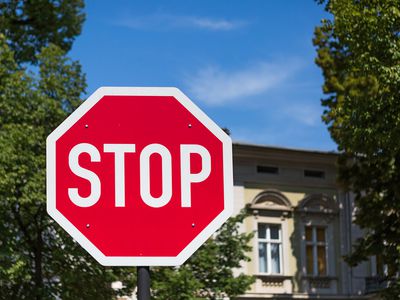 STOP-sign with facade in the background