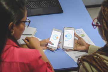 Two young people sending money through a money-sending app.