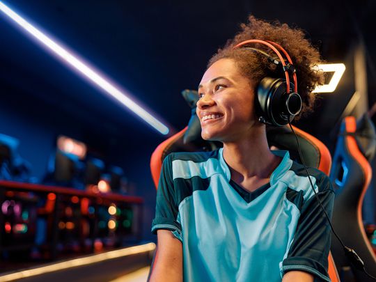 A gamer wearing headphones at a tournament.