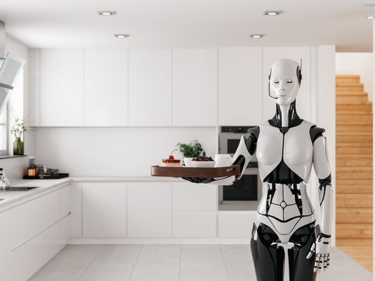 A robot butler in a kitchen, holding a tray of food