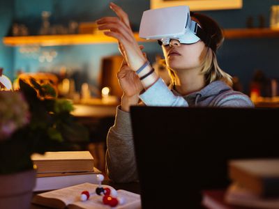 Someone using a VR headset in a home office. 