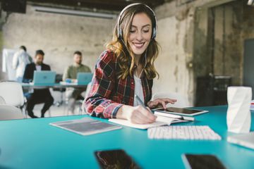 Woman with headphones on using tablet