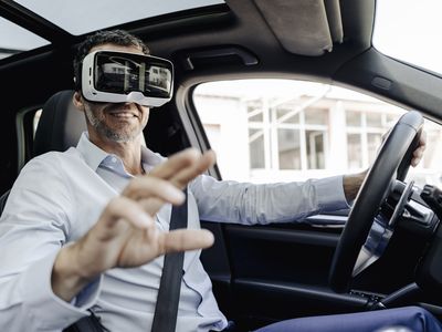 Businessman wearing VR glasses driving a car