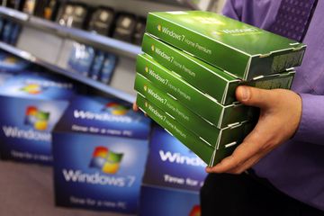 Man carrying retail boxes of Windows 7