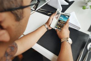 A man using an Android phone at the table.