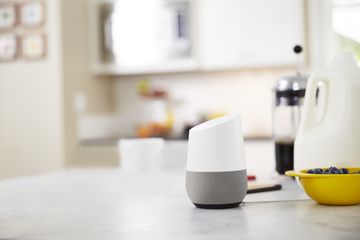 A Google Home smart speaker in a kitchen.