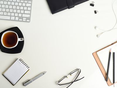 White office desk with a lot of things on it